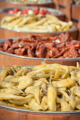 Fresh peppers in barrels on street market. Healthy food containing vitamins. Mediterranean snack