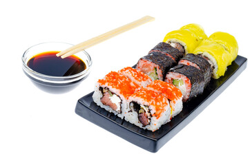 Set of different rolls on black plate on white background.