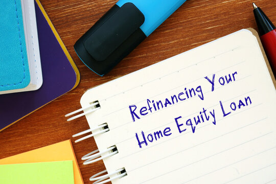 Conceptual photo about Refinancing Your Home Equity Loan with handwritten phrase.