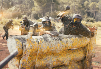 Fototapeta premium Portrait of man and woman paintball players in full gear on playing field