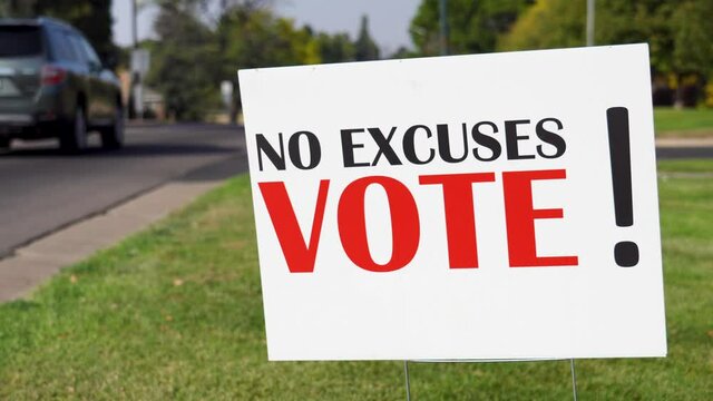 Political Voter Rally Sign Next to Road with Cars Driving By Close Up, No Excuses Vote! - Powered by Adobe