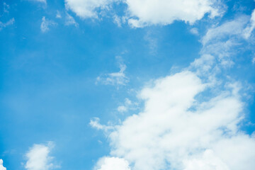 Cloudscape with fluffy white cloud in blue sky.