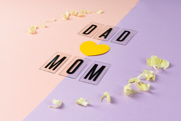 Dad and mom on pink and purple background with flower in circle shape.