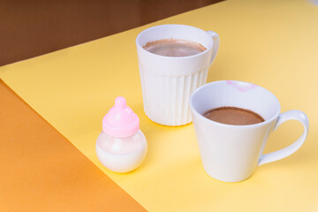 Breakfast hot drink for family with milk bottle and two coffee cups.