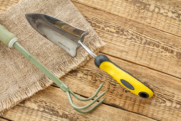 Garden tools on sackcloth and wooden boards.