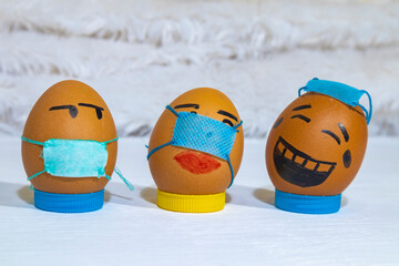 Several painted eggs wearing masks