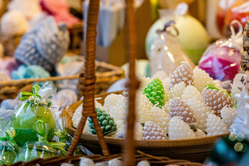 basket with white cone-shaped candles at the Christmas market, close-up, selective focus