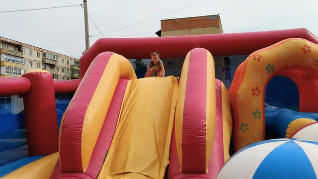 girl jumps on inflatable trampoline