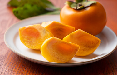 Cut Japanese persimmons on a plate