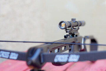 Fototapeta na wymiar The optical sight at the crossbow close-up. Details of the weapon. Hunting concept
