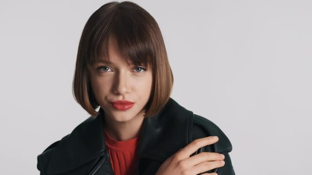 Gorgeous fashion girl with bob hair confidently looking in camera. Stylish professional model sensually posing in studio