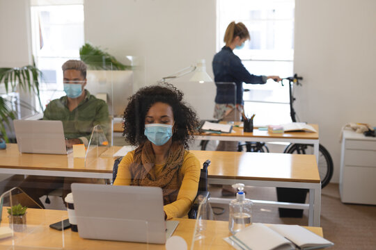 Office colleagues wearing face masks working in office