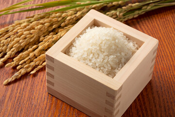 Rice in a Japanese Masu in a wooden background