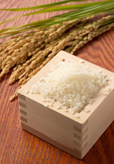 Rice in a Japanese Masu in a wooden background
