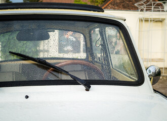 Old car with water droplets on the windscreen