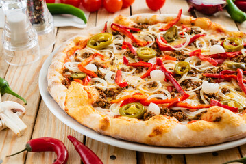 tasty pizza on the wooden background