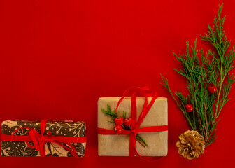 Christmas and New Year card, background - spruce, gifts on a red background, symmetry. Flat lay, copy space, top view