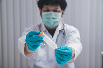 Doctor or medical staff is collecting secretions from patient for examination in the lab. Pandemic Coronavirus, COVID-19.