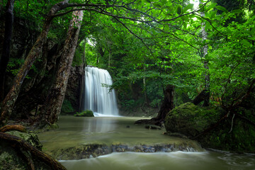 A beautiful waterfall deep in the tropical forest, steep mountain adventure in the rainforest.