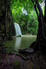 A beautiful waterfall deep in the tropical forest, steep mountain adventure in the rainforest.