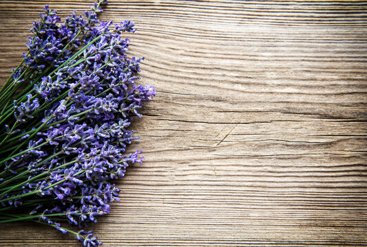 Fresh flowers of lavender bouquet, top view on old wooden background