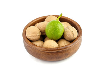 Walnuts in round plate isolated on white background