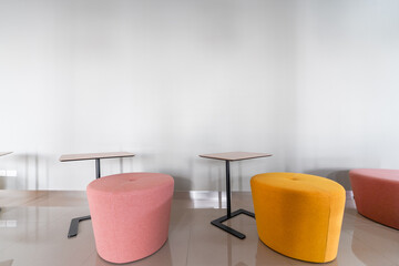 Colorful armchair in minimal modern style with empty wall background in natural light setting / interior / copy space