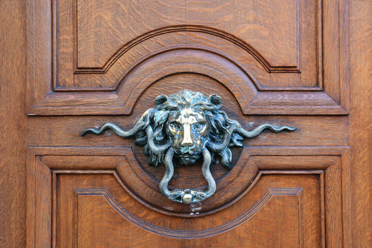 European Vintage old bronze lion head and snakes door knocker and doorknob.Paris,France