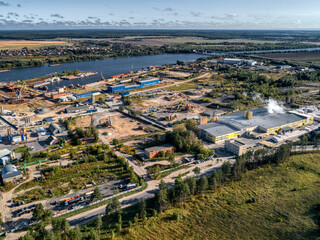 Fototapeta premium industrial plant on the bank of a large river, aerial view.