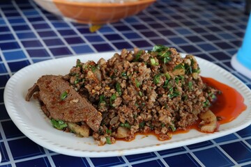 Minced Pork Larb with Fresh Vegetables Spicy Minced Pork Salad is a popular traditional Thai dish in the North and Isan regions of Thailand. Spicy Minced Pork Salad Called Larb Moo Thai food concept.