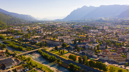 Scenic aerial view of French town of Albertville in green alpine valley on Arly River on sunny summer day