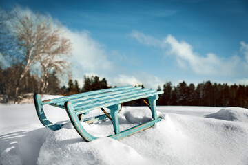 Beautiful winter time landscape with deep snow and a wooden sledge