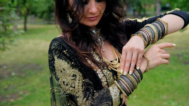 Portrait of a female model in ethnic indian costume with  jewellery and traditional makeup.