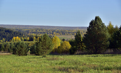 Autumn colors of the Ural forest and agricultural fields. Dry and warm autumn in the foothills of the Western Urals.