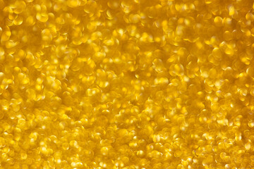 Golden abstract defocused bokeh background. Sparkling texture