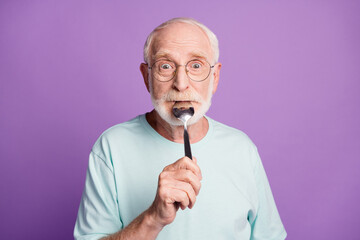 Careless funny dream old man hold spoon in mouth joking while waiting for delicious meal wear blue...