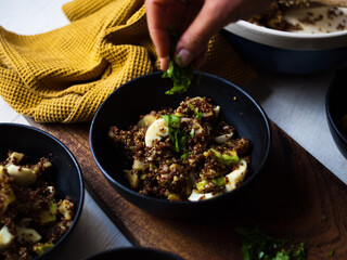 Avocado, egg, quinoa curry salad. Whole foods home made on rustic farm table in natural light