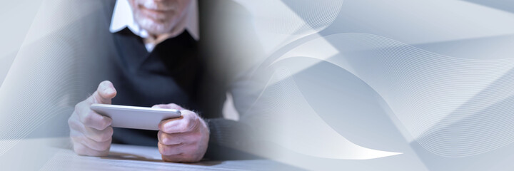 Man using his mobile phone; panoramic banner