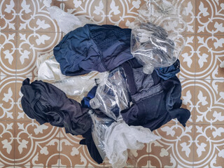 Pile of clothing and plastic waste representing micro waste pollution when doing laundry