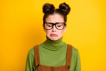 Closeup photo of attractive sad lady two funny buns geek nerd a-student failed examination crying unhappy wear specs green pullover brown overall isolated yellow color background