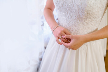 Obraz na płótnie Canvas bride hands arranging her ring before the ceremony