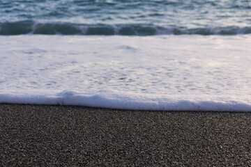 Beach sand and foam water with copy space