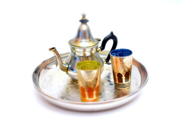 Obraz na płótnie Canvas Group of teapot and glasses of oriental tea on a tray on white background