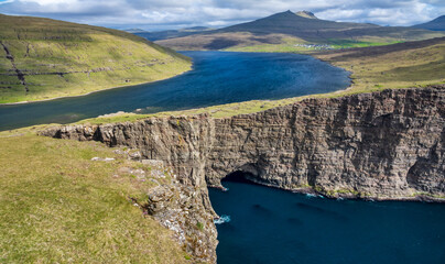 Iconic lake and ocean cliffs in Faroe Islands