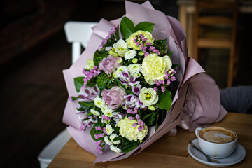 Bouquet of fresh delicate flowers on a dark shady blured background gift