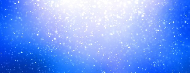 Falling snow blurred pattern on blue empty background. Wide format banner for winter decoration.