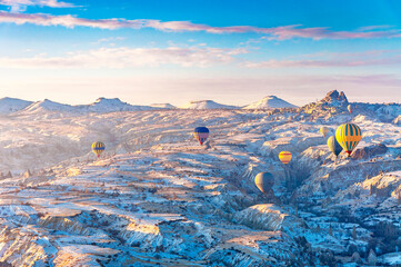 Hot air balloons are flying over Cappadocia. Cappadocia is the most populer tourist destination in Turkey.