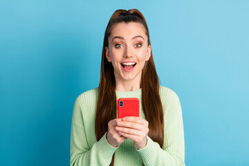 Close-up portrait of her she nice attractive lovely pretty cheerful cheery amazed brown-haired girl using device fast speed 5g app isolated bright vivid shine vibrant blue color background