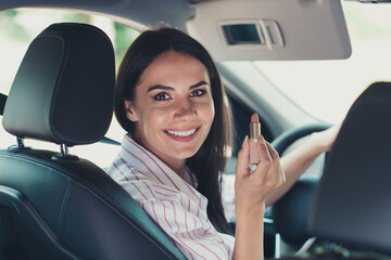 Close-up profile side view portrait of her she nice attractive lovely pretty successful cheerful content girlfriend worker riding car early morning making visage applying nude lip balm