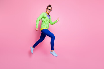 Fototapeta na wymiar Full length profile side photo cheerful high school girl jump run copyspace after dreamy discounts wear green shirt style stylish trendy trousers isolated pastel color background